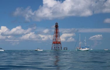 boats on calm water at lighthouse Florida Keys Sombrero